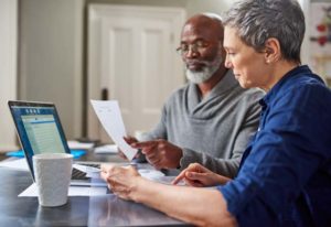 two people reviewing holistic approach to managing retirement plans